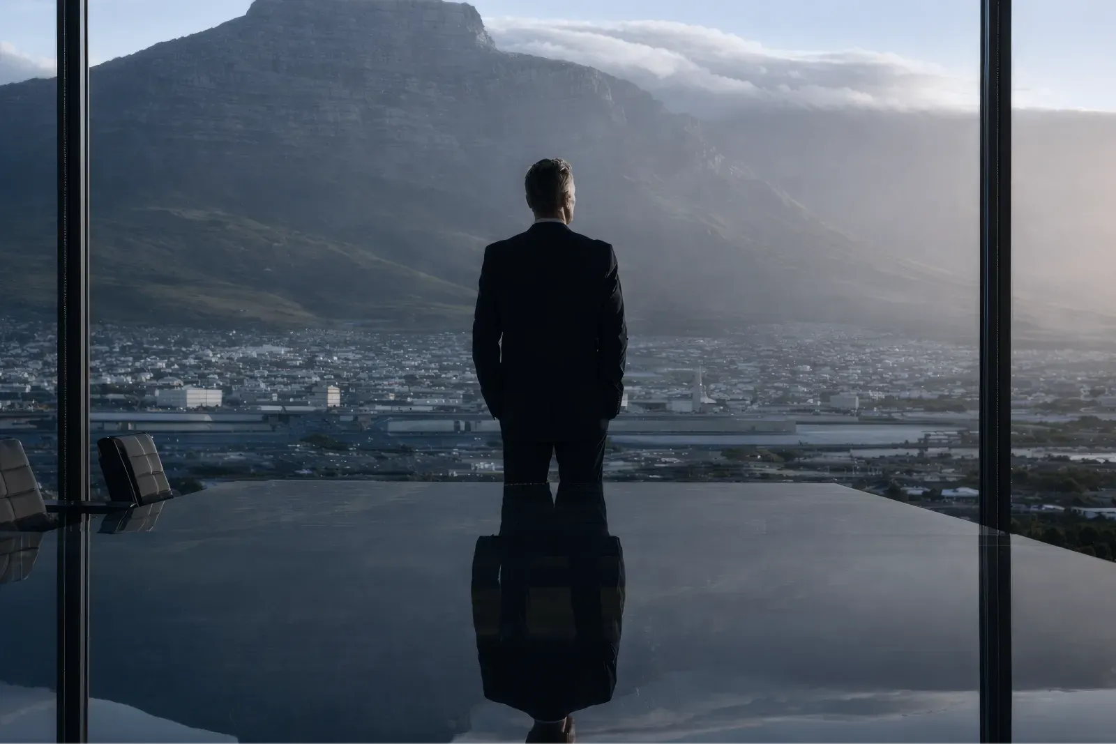 Businessman overlooking a mountain landscape